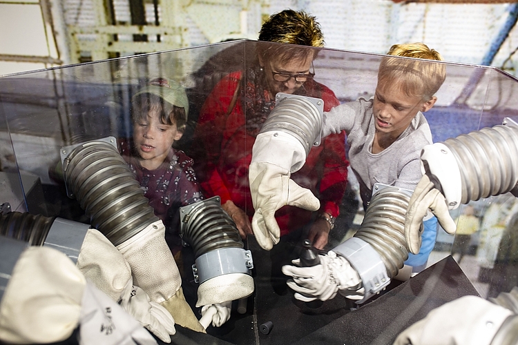 Mit klobigen Astronautenhandschuhen ausgestattet, trainierten (von links) Morris, Heidi und Marvin Stirnemann das Basteln im Weltraum.